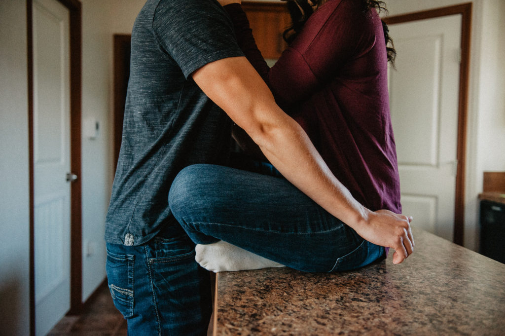intimate in-home couples' photo with warm colours and soft light.