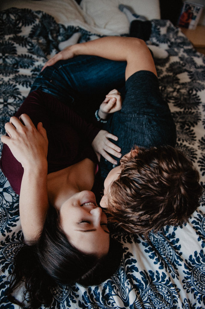 intimate in-home couples' photo with warm colours and soft light.