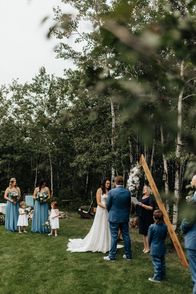 bride and groom at altar during intimate backyard wedding ceremony