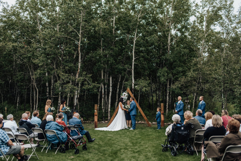 bride and groom at altar during intimate backyard wedding ceremony